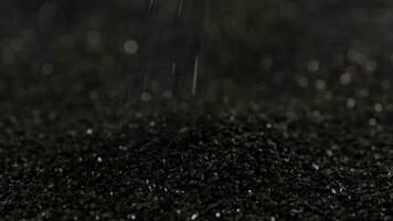 sprinkling black coconut charcoal close-up slo-mo, activated carbon video