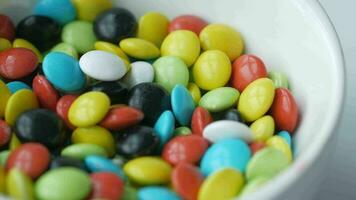 colorful jelly beans on a plate on table , video