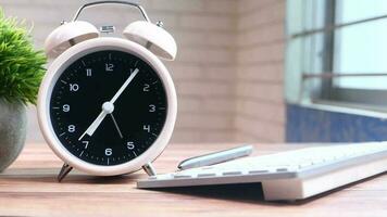 Tea cup laptop and clock on table close up video