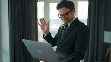 Caucasian Man Dressed in a Jacket and Underwear Using Laptop To Make a Video Call From Home