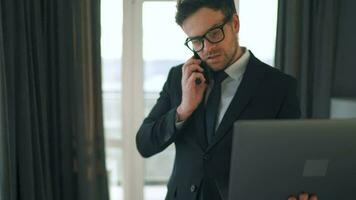 Caucasian Man Dressed in a Jacket and Underwear Using Laptop To Make a Video Call From Home