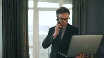 Caucasian Man Dressed in a Jacket and Underwear Using Laptop To Make a Video Call From Home