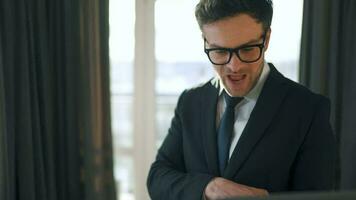 Caucasian Man Dressed in a Jacket and Underwear Using Laptop To Make a Video Call From Home