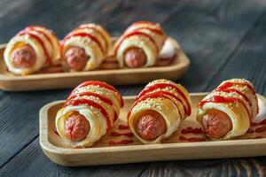 Sausage rolls on the wooden tray photo