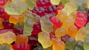 full frame looped spinning background of colorful jelly bear candies video