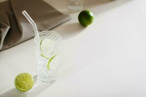 Hard seltzer with ice and lime in glasses on the table photo