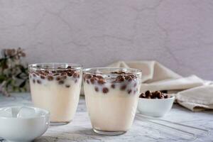 Bubble milk tea with ice in glasses on the table photo