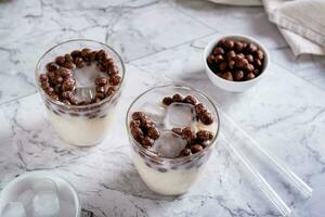 Homemade milk bubble tea with ice in glasses on the table photo