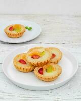 Small fruit pia cake on a textured white background. Kue Pia Buah. photo