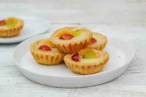 Small fruit pia cake on a textured white background. Kue Pia Buah. photo