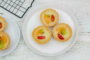 Small fruit pia cake on a textured white background. Kue Pia Buah. photo