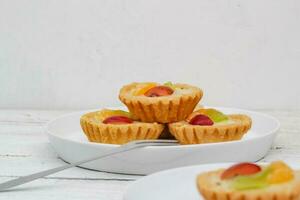 Small fruit pia cake on a textured white background. Kue Pia Buah. photo