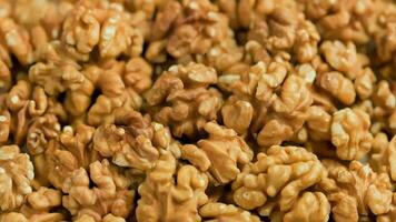 looped spinning walnuts without the shell close-up full frame background video