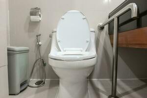 Toilet and handrail for elderly people at the bathroom in hospital, safty and medical concept photo