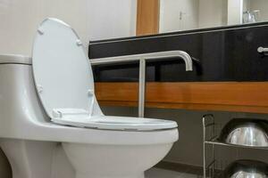 Toilet and handrail for elderly people at the bathroom in hospital, safty and medical concept photo