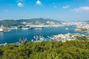 Nagasaki,Kyushu,Japan - October 24, 2018 Panorama view of Nagasaki city and Nagasaki port with montain background, cityscape photo