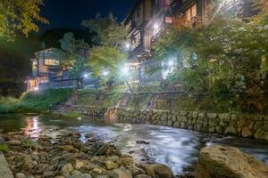 Hot spring towns, Kurokawa Onsen, Ryokan and bridge at night with lighting flare, Kurokawa, Kumamoto, Kyushu, Japan photo