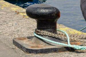 Rusty metal mooring bollard for big ship photo