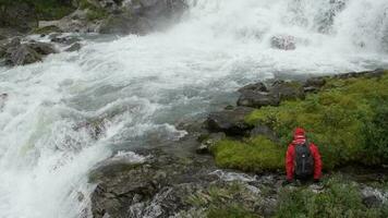 Caucasian Hiker Exploring Scenic Waterfall in the Wilderness. Slow Motion Footage video
