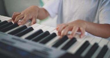 Cute boy enjoy to learning playing piano at home photo