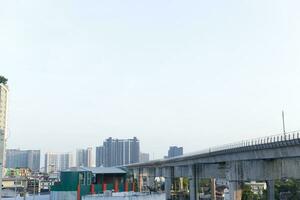 no clouds sky and the city building below background photo