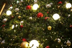 close up decoration ball and light bulb on christmas tree at night photo