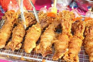 street market food deep fried squids photo