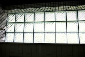 glass block with light through window in bathroom toilet with shadow photo