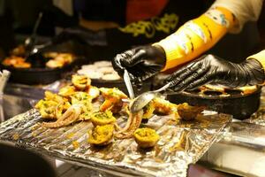 kind of Thai sweetmeat with seafood , octopus in street market photo