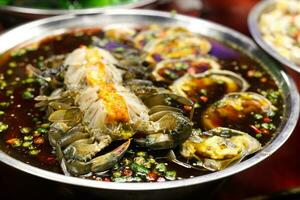 thai spicy pickled crab salad sell in thai street market photo