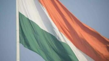 India flag flying high at Connaught Place with pride in blue sky, India flag fluttering, Indian Flag on Independence Day and Republic Day of India, tilt up shot, Waving Indian flag, Har Ghar Tiranga video