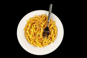 Plate of raw pasta photo