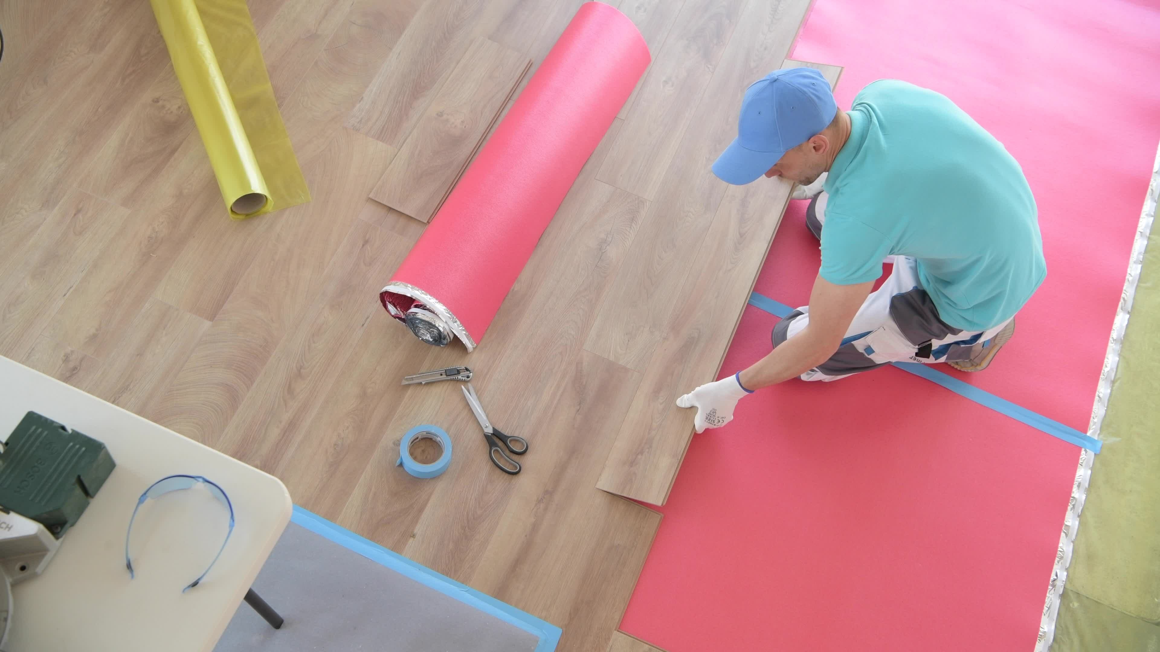 Wooden Floor Panel Installing By Professional Flooring Installer Wooden Floor Panel Installing By Professional Flooring Installer