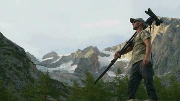 Photographer with Camera Equipment in Scenic Alpine Region video