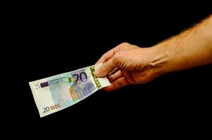 Hand holding a 20 euro bill photo