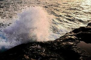 Waves hitting rocks photo