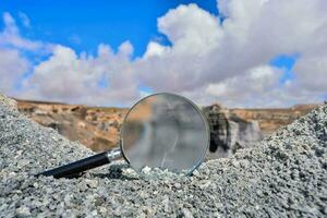 Magnifier on rocky mountains photo