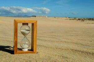 Hourglass on the sand photo