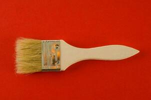 Paint brush on red background photo