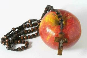 Fresh red apple with crucifix photo