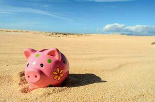 Piggy bank on the sand photo