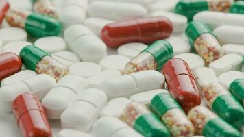 different types of medical pills and capsules rotating on white surface video