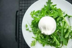 buratta salad green leaves arugula cheese burratina healthy meal food snack on the table copy space food background rustic top view photo