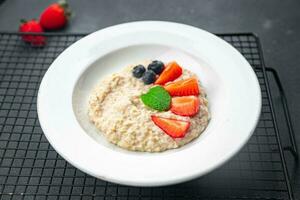 oatmeal porridge with berries tasty breakfast healthy meal food snack on the table copy space food background rustic top view photo
