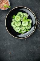 cucumber green salad fresh vegetable meal food snack on the table copy space food background rustic top view photo