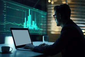Side View of Handsome Businessman Using Laptop and Sitting at Desk with Green Financial Dashboard In Dark Room. Illustration. photo