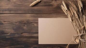 Top View of Blank Kraft Paper Mockup and Golden Dried Grain Grass on Vintage Wooden Table, . photo