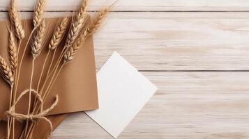 Top View of Brown and White Paper Sheet Mockup and Golden Dried Grain Grass on Wooden Table. . photo