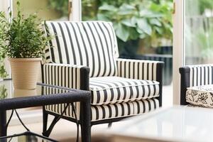 moderno elegante jardín mueble con a rayas modelo en el conservatorio en el campo casa. generativo ai foto