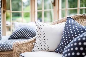 Pillows and cushions with polka dot pattern in the conservatory in countryside cottage, home decor and interior design. photo